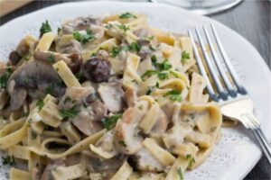 Tagliatelle pasta cutter attachment for perfect Italian dish with mushrooms